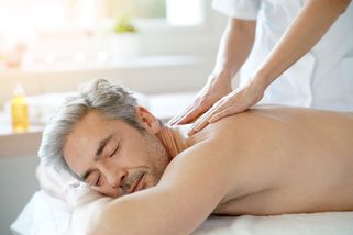 a man enjoys a back massage, an excellent healing therapy