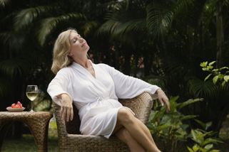 lady relaxing in a spa robe, breathing in the clean air