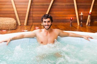 a man enjoying the jacuzzi on his thermal therapy holiday