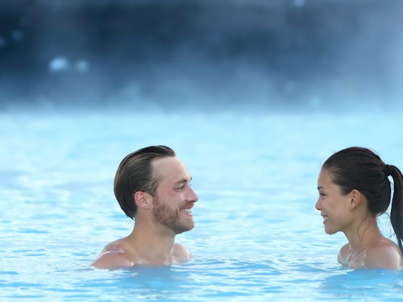 two people swimming in a thermal pool
