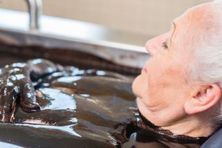 a woman enjoys a mud bath